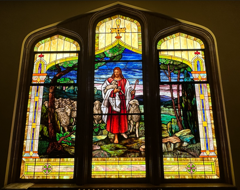 The Shepherd's window: a stained glass depiction of Christ the Good Shepherd carrying a lamb